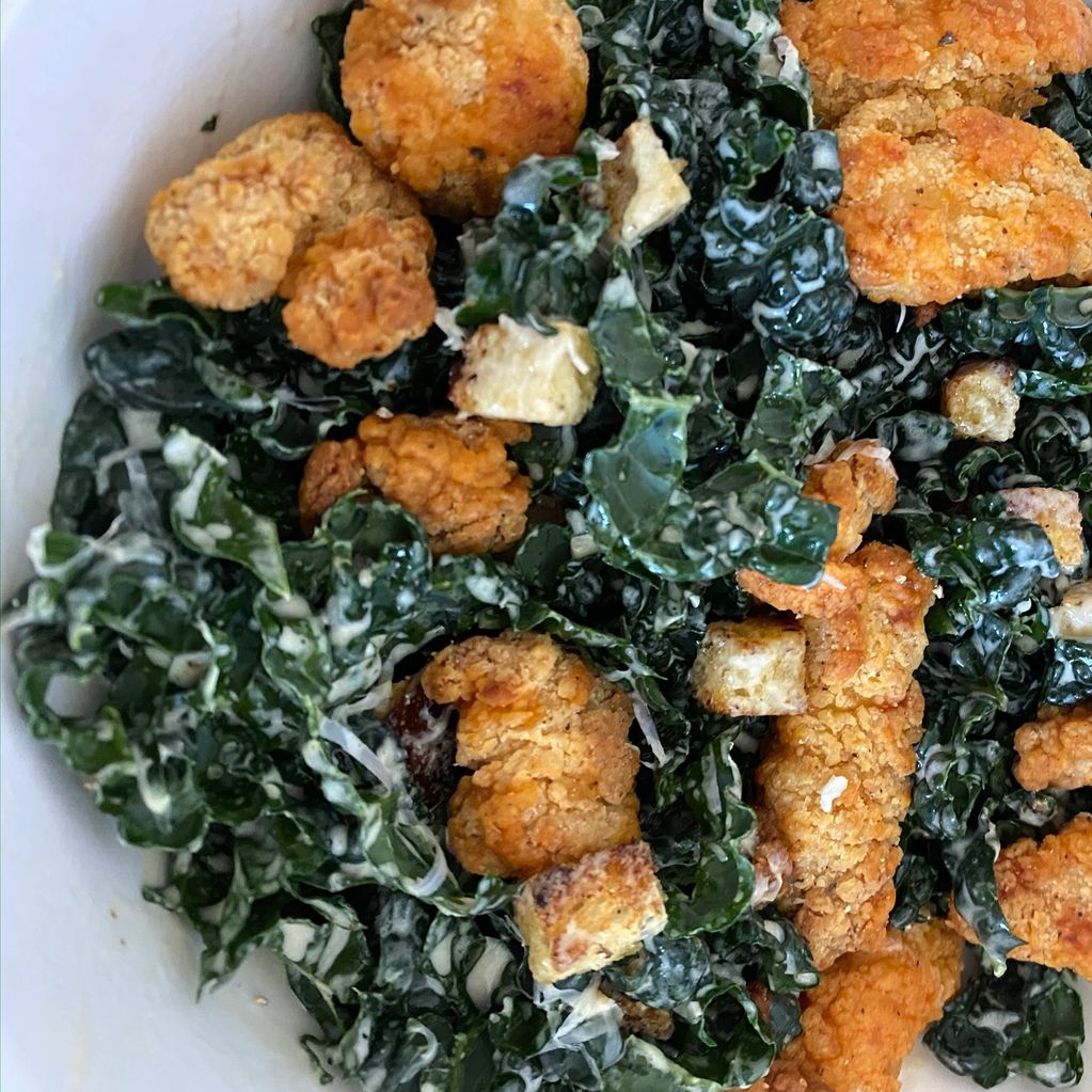 kale caesar salad with buffalo chicken