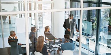 Business team in a modern meeting room with a presenter speaking.