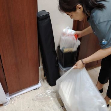 Person disposing of trash into a bin