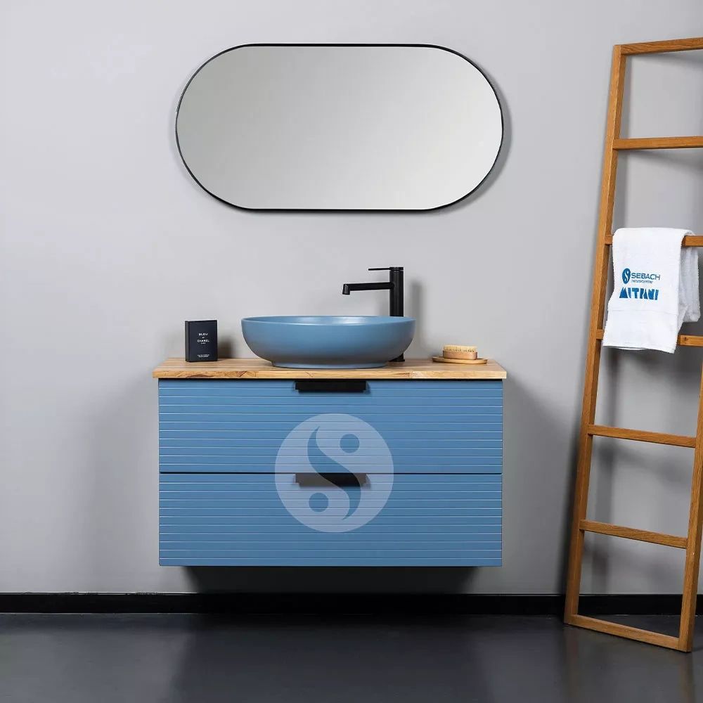 Modern bathroom vanity with blue cabinet and round mirror.