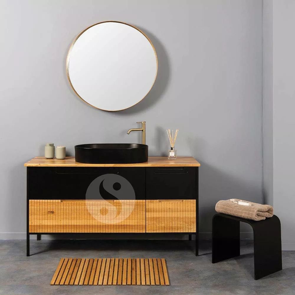 Modern bathroom vanity with round mirror and decorative accessories.