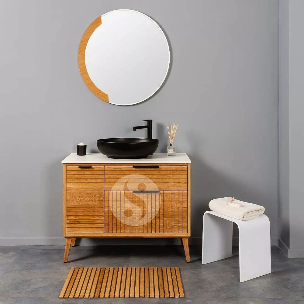 Modern wooden bathroom vanity with round mirror and stool.
