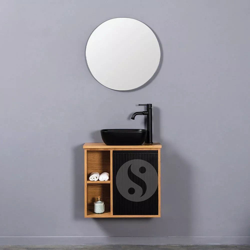 Modern bathroom vanity with round mirror and black sink.