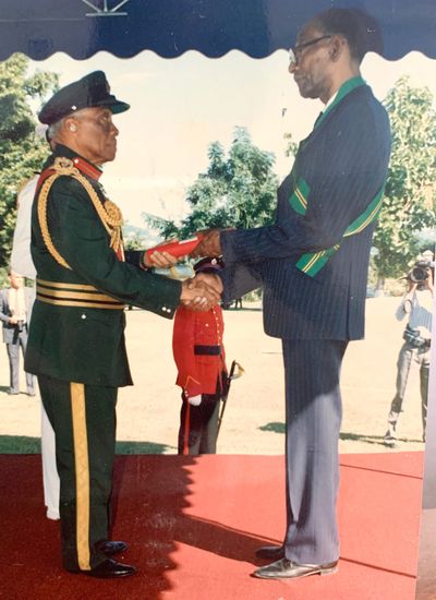 Sir Florizel Glasspole, Governor General of Jamaica, confers Dr Arthur Wint with the Order of Jamaic