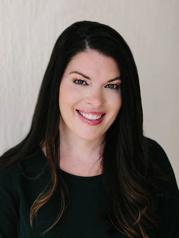 Woman smiling with dark hair. 