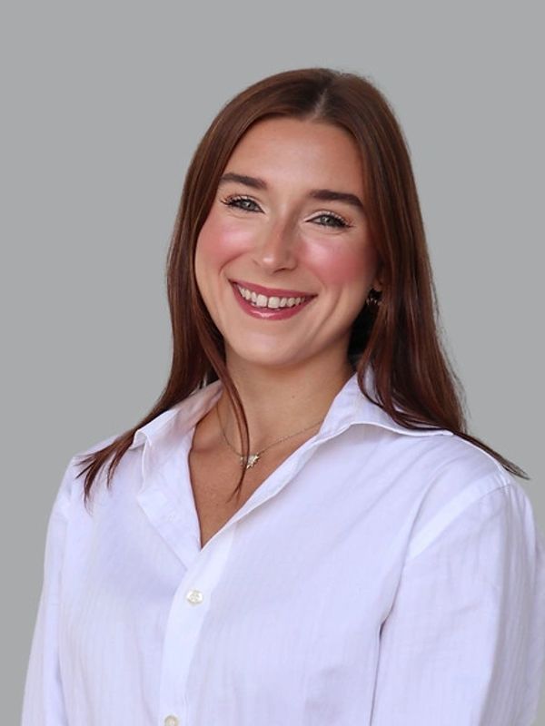 Woman with brown hair smiling. 