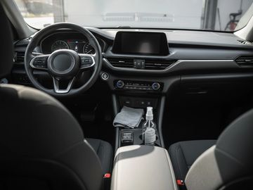 Clean and detailed car interior with a focus on the dashboard and steering wheel.