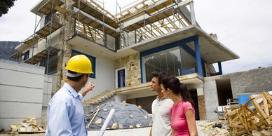 Construction worker shows a couple their new home under construction.