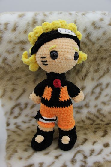 Crocheted Naruto doll with bright yellow hair.