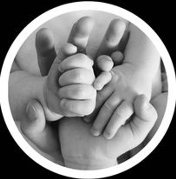 Close-up of intertwined adult and baby hands symbolizing care and protection.
