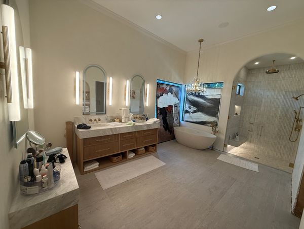 Modern bathroom with dual sinks, a freestanding tub, and a spacious glass shower.