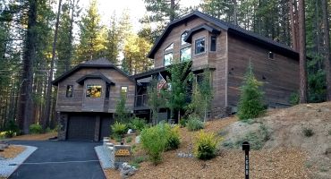 Modern wooden house in a forested area.