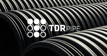 Rows of large black pipes with TDR Pipe logo.