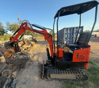 Excavator moving tree branches