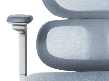 Close-up of a modern office chair's armrest and mesh backrest in gray.