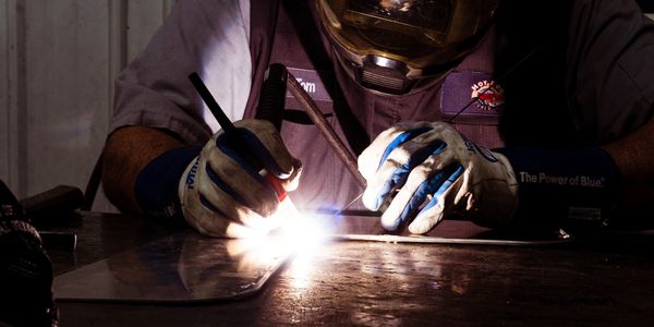 Metal fabricator welding patch metal for custom build