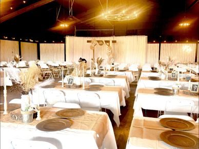 Elegant banquet hall with neatly arranged tables and rustic decor.