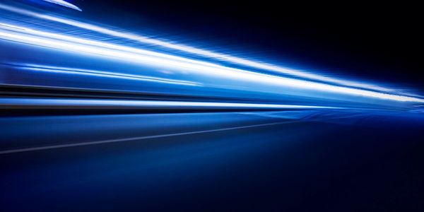 Blue light streaks creating a dynamic, futuristic motion effect.