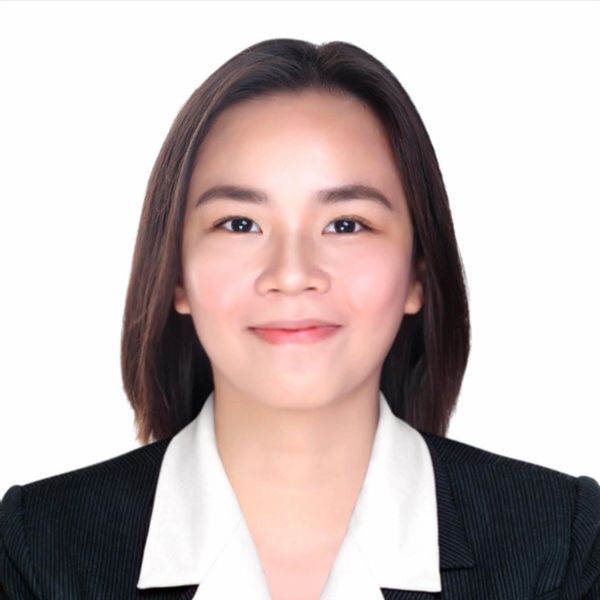 Professional portrait of a woman in business attire against a white background.