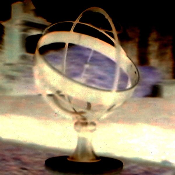 Image of a globe sundial in London; the photo has been negatized, solarized and colors manipulated.