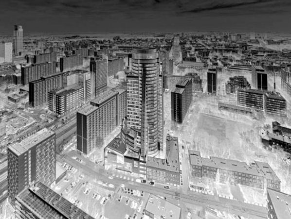 High-angle overhead panoramic view of a Polish city, negatized - so the setting seems otherworldly.