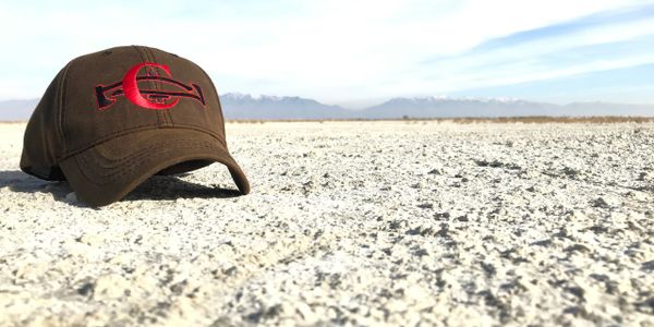 A baseball cap on the beach sand