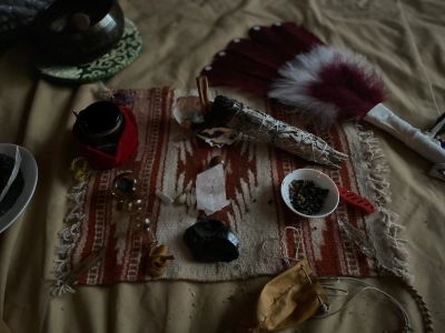Spiritual and ritual items arranged on a patterned cloth.