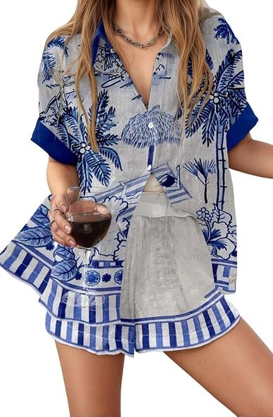 Woman wearing blue and white floral print pajamas holding a glass of wine.