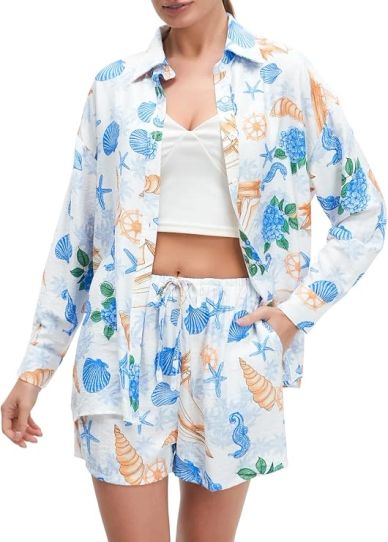 Woman wearing a seashell and ocean-themed shirt and shorts set.