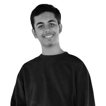 Smiling young man in a dark sweatshirt against a white background.