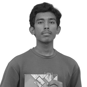 Young man holding an ICSE Foundation Mathematics textbook.