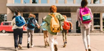 Children walking to school with backpacks.