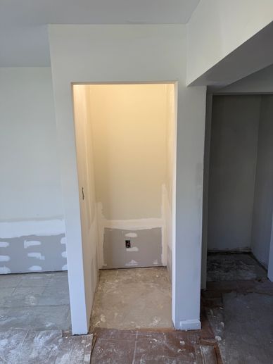 Small unfinished closet or alcove in a room under renovation.
