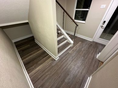 Interior hallway with stairs and wooden flooring.