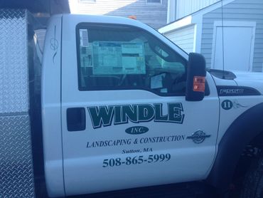 Truck lettering: vinyl graphics applied to truck. Windle Landscaping, Millbury, MA