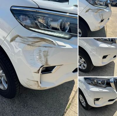 Bumper bar dent, bumper bar damage, car bumper repairs, bumper repair on a white prado.