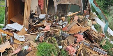 Debris and wreckage of a destroyed structure scattered on the ground.