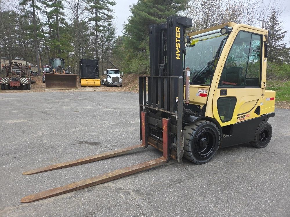 Yellow Hyster forklift parked on an outdoor paved area.