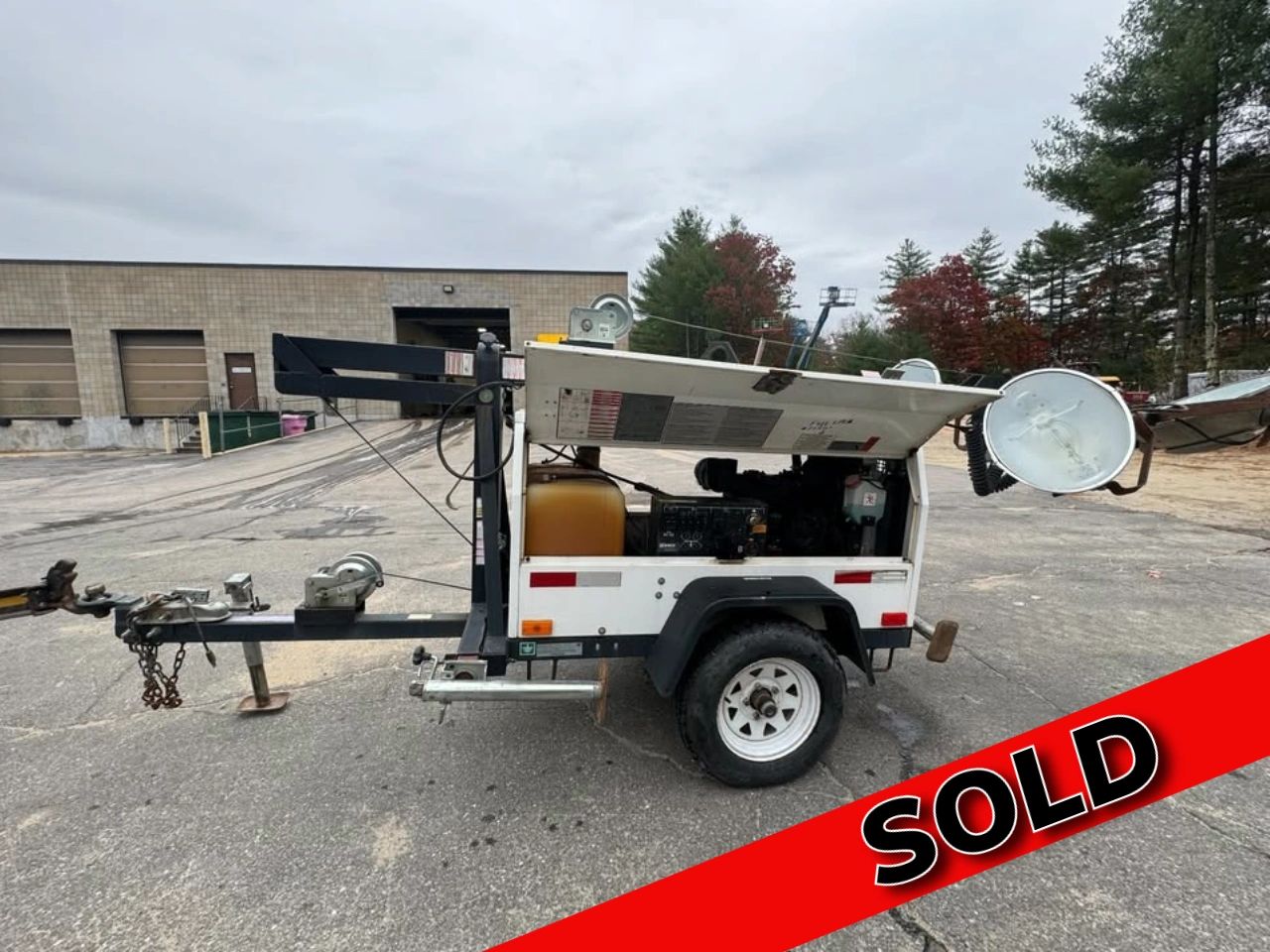 Portable light tower trailer with equipment, marked as sold.