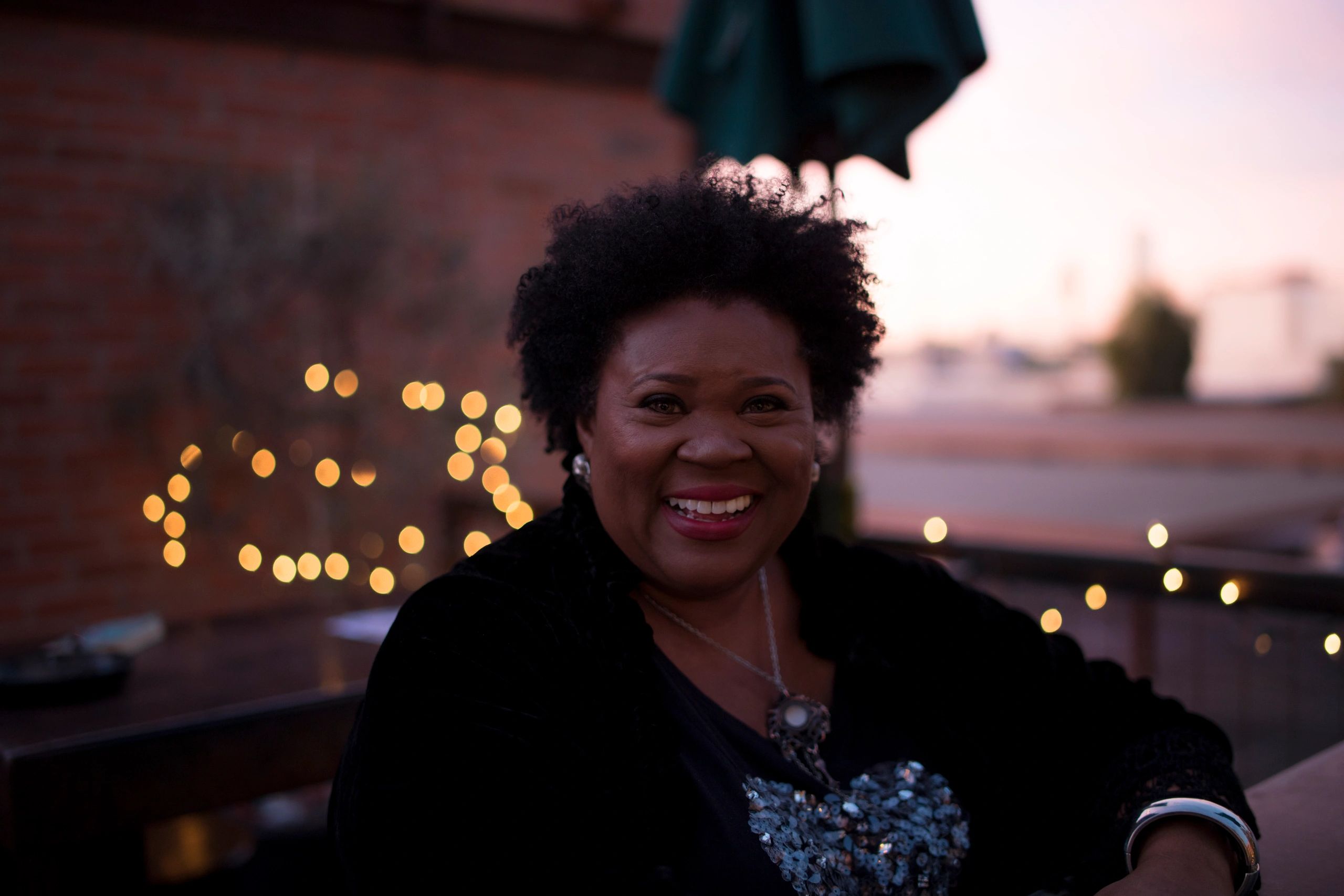 Urban street view with a worn pedestrian crossing and a person walking away.