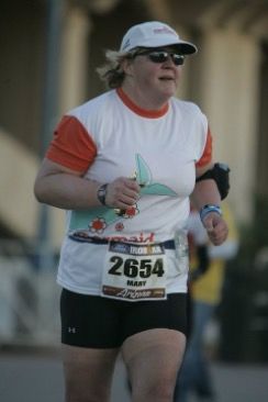 A large-sized woman running at the Arizona Ironman