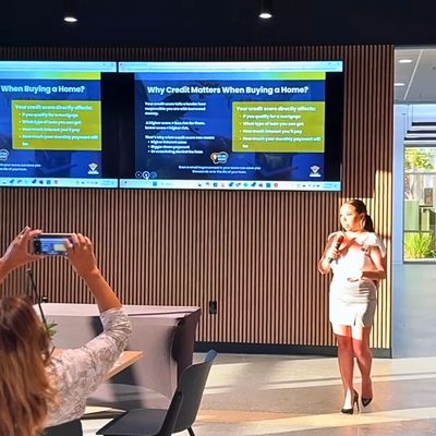 Credit Coach Ruby Speaking at a community event