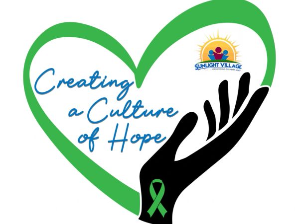 Green heart with black hand and hope message.