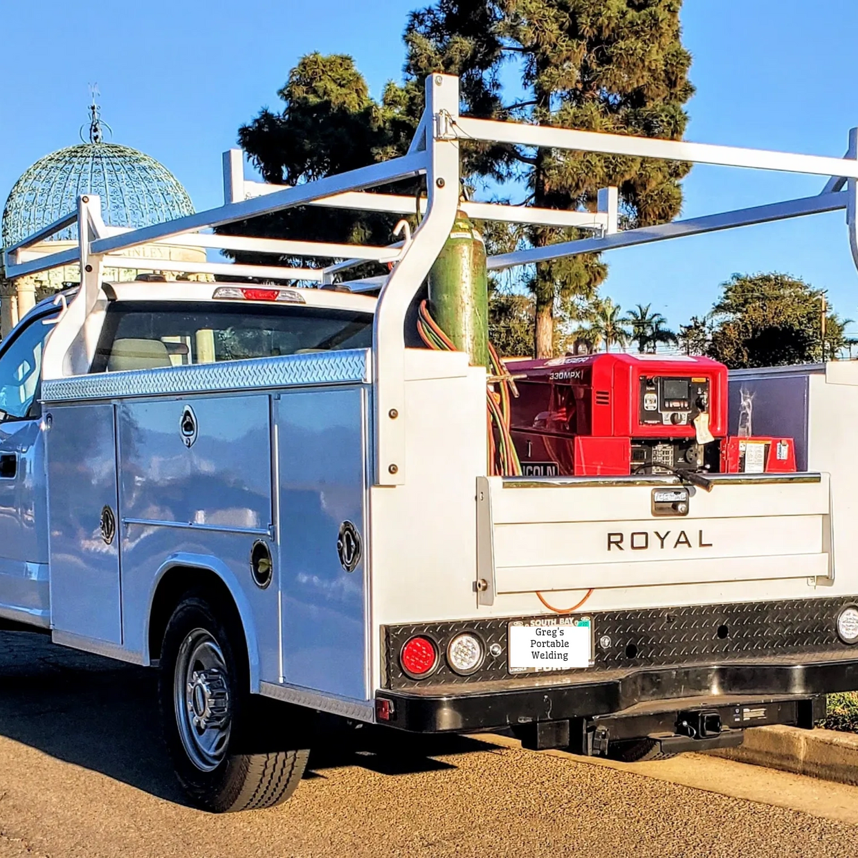 White Ford work truck with Lincoln welder in truck bed. Greg's Portable Welding 