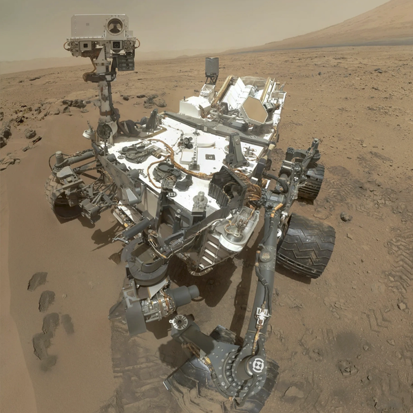 Mars rover navigating rocky terrain on the dusty Martian surface.