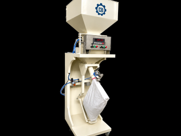 Industrial packaging machine filling a large bag.