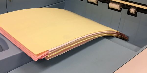 3 Part Carbonless paper on output tray of printing machine