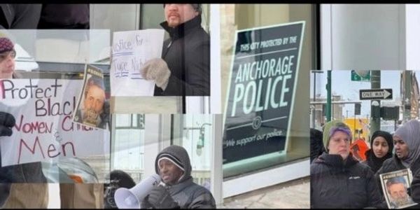 Protesters holding signs advocating for justice and protection for Black women and men near Anchorage Police.