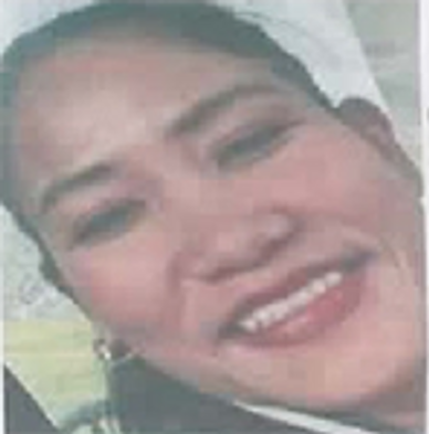 Close-up of a smiling person with short hair and red lipstick.