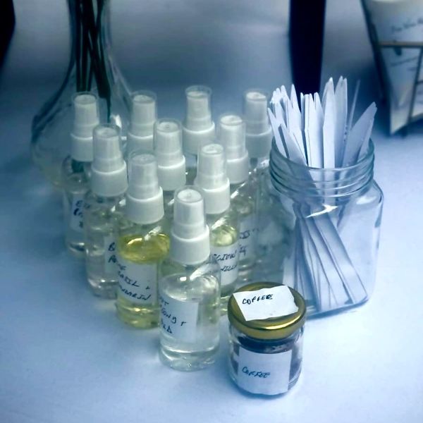 Collection of small spray bottles and a jar labeled 'coffee'.